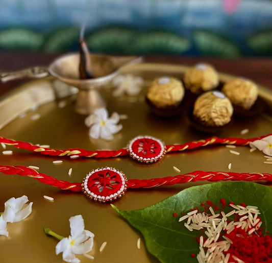 Red mirror work rakhi  (set of 2) with rice & tilak